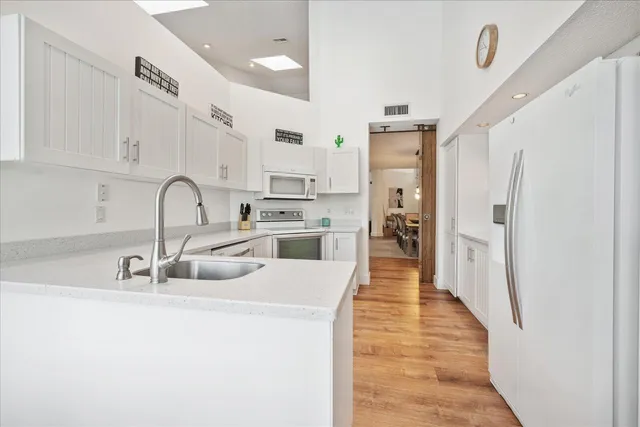 a kitchen with stainless steel appliances a sink a stove and refrigerator
