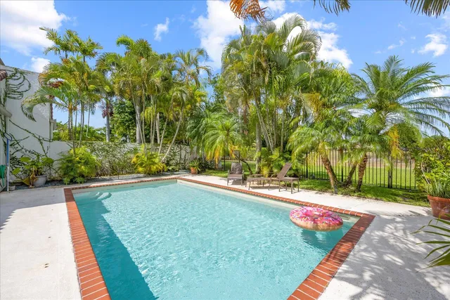 a swimming pool with outdoor seating and yard