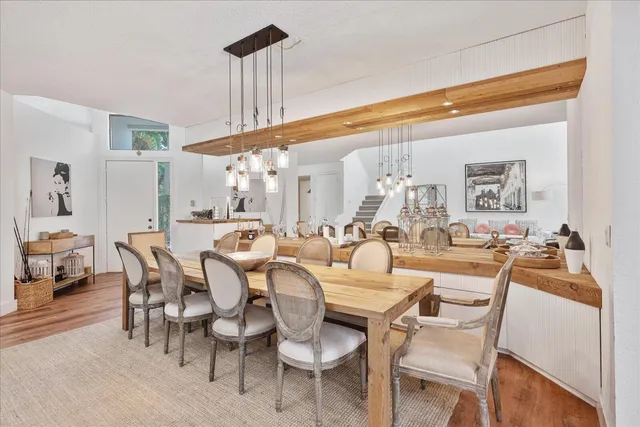 a dining room with furniture and a large window