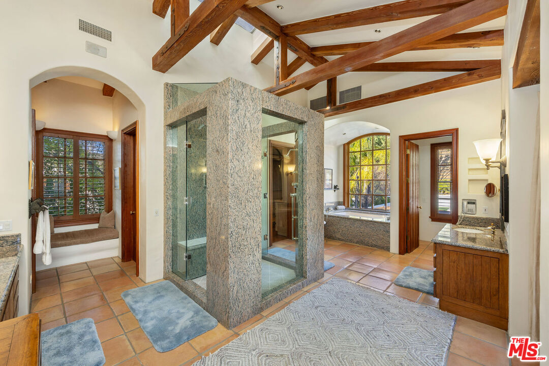 25127 Jim Bridger Road Hidden Hills, CA 91302 - Photo 24 of 50 a view of a hallway with wooden floor and a living room
