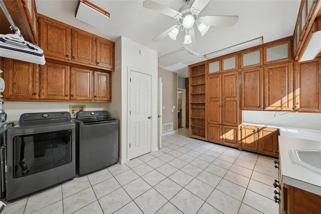 a kitchen with stainless steel appliances granite countertop a refrigerator a stove and a sink with cabinets