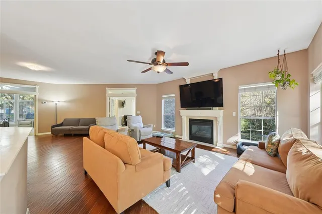 a living room with furniture fireplace and a large window