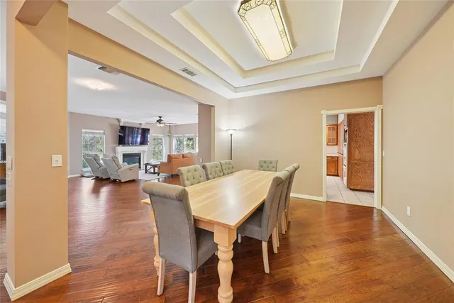 a view of a dining room with furniture and wooden floor