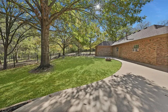 a view of a backyard with large trees