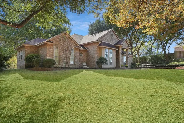 a front view of house with yard and green space