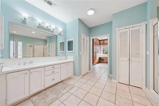 a bathroom with a sink a mirror and a shower