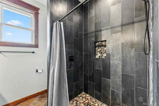 a bathroom with a shower and a sink