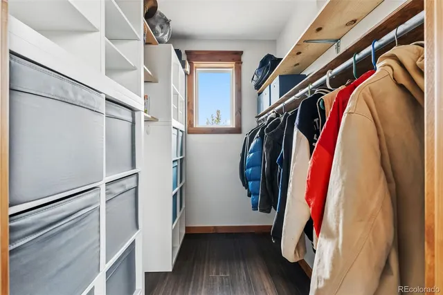 a view of walk in closet with clothes and shoes