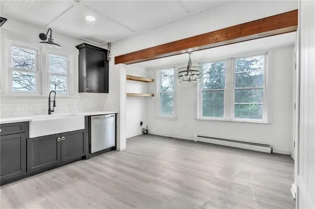 a view of a large kitchen with windows and chandelier