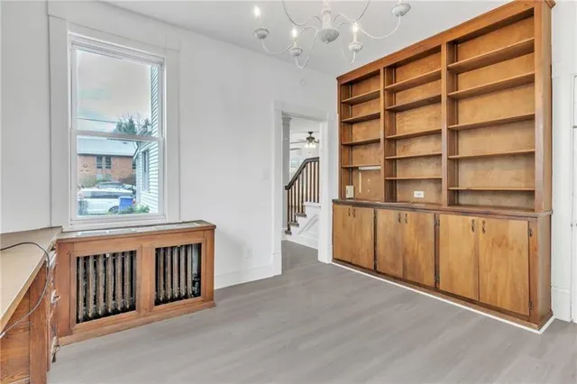 a view of a room with wooden floor and windows