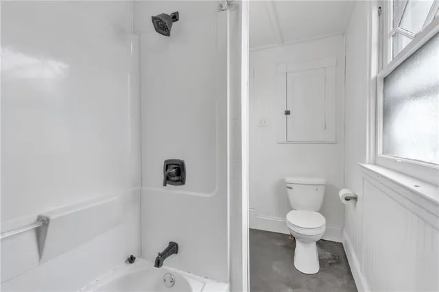a white toilet sitting next to a bathroom sink