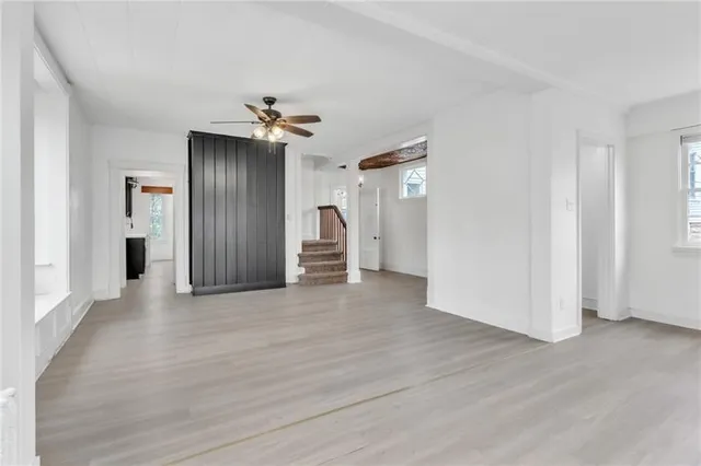 a view of a kitchen with wooden floor and a ceiling fan