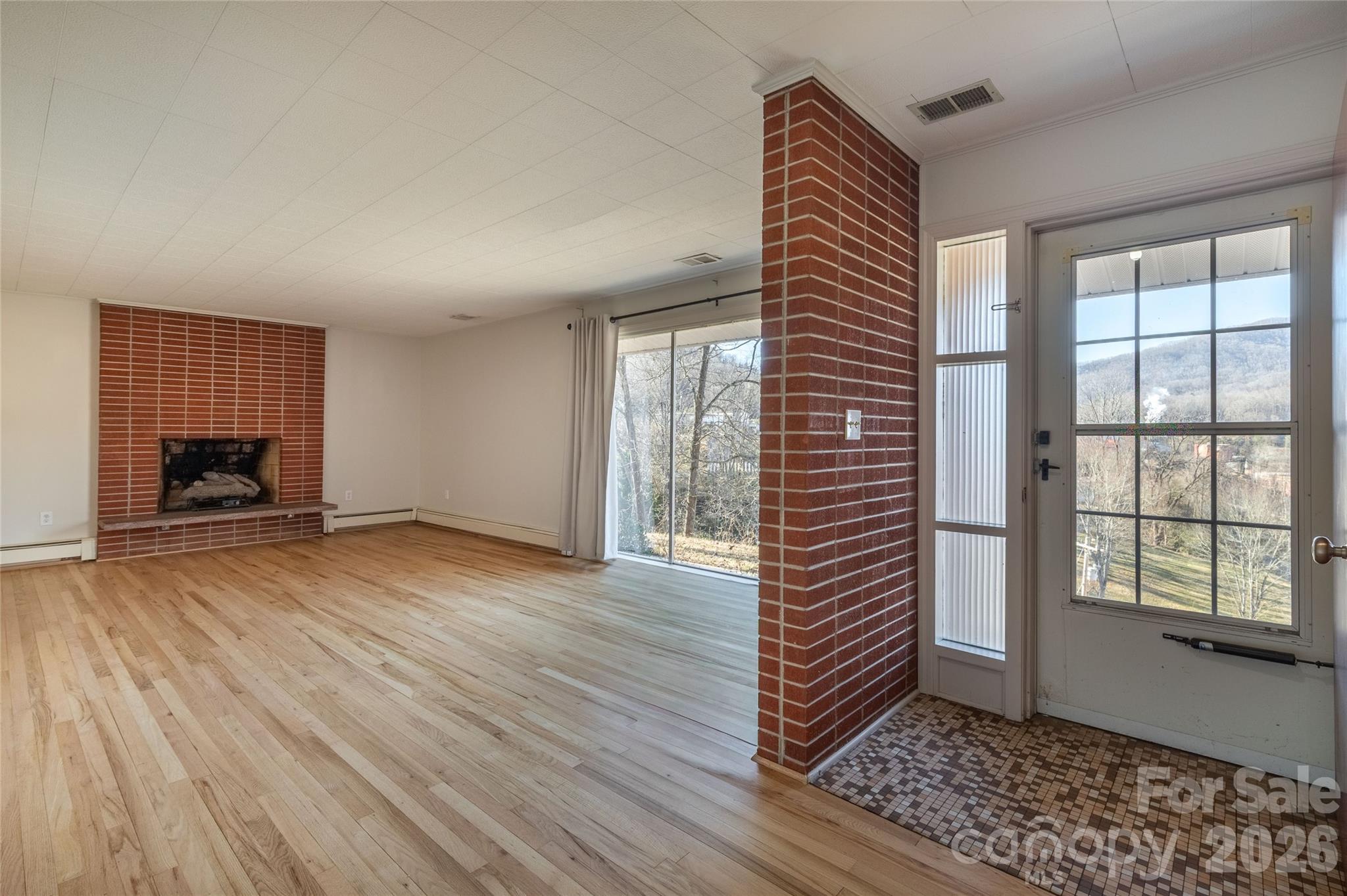 223 Cherry Street Sylva, NC 28779 - Photo 15 of 29 a view of empty room with wooden floor and fan