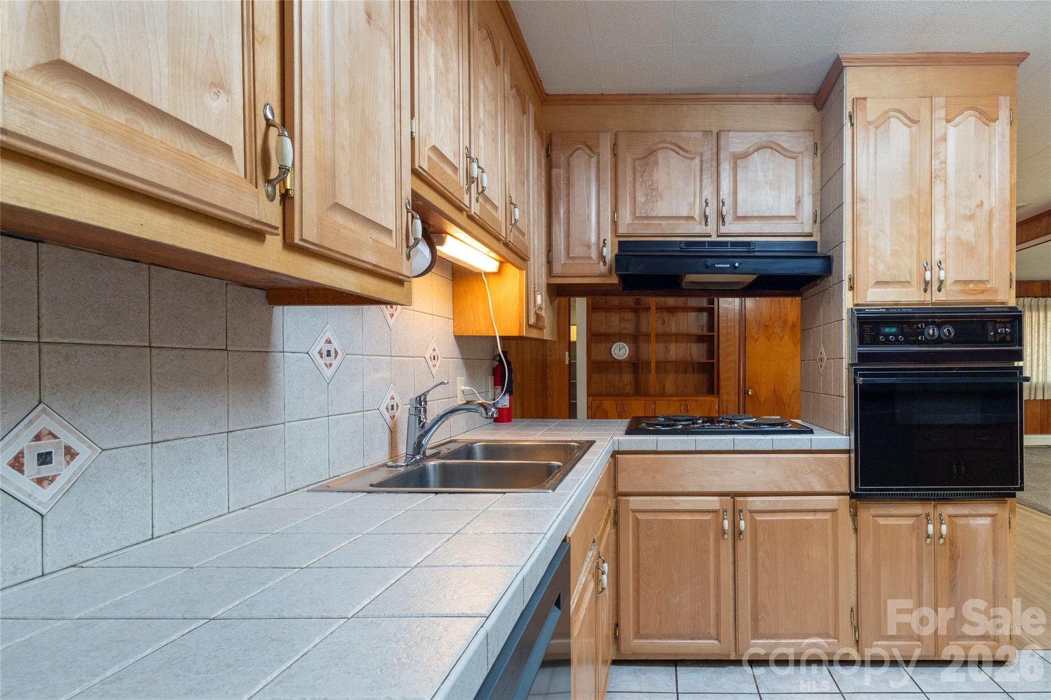 223 Cherry Street Sylva, NC 28779 - Photo 18 of 29 a kitchen with granite countertop a sink a stove and cabinets