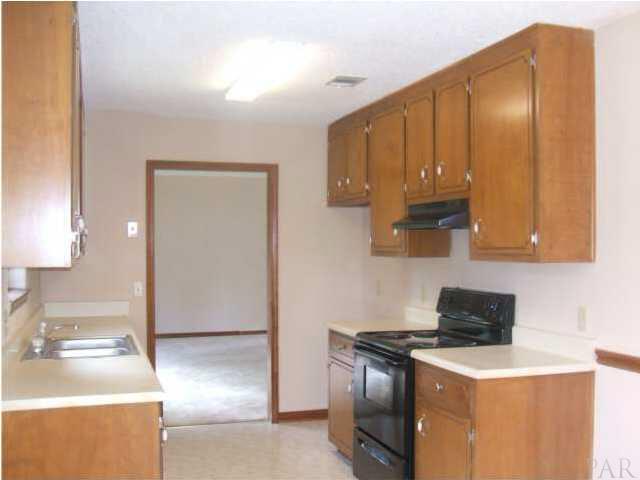 725 Valley Ridge Way Pensacola, FL 32514 - Photo 5 of 9 Kitchen with New Stove and Range Hood. New Vinyl Flooring