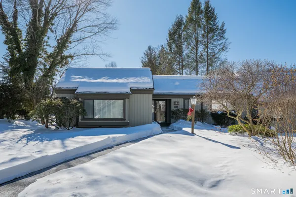 a view of a house with a yard and sitting area