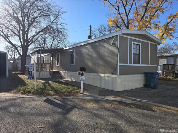 a view of a small house with a yard