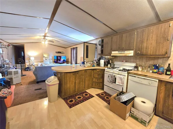 a kitchen with a sink appliances and cabinets