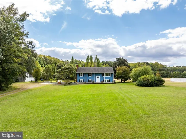 a view of an house with backyard space and a lake view