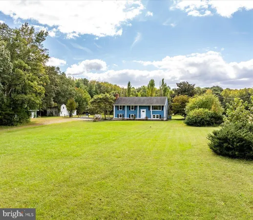 a view of an house with backyard space and a lake view