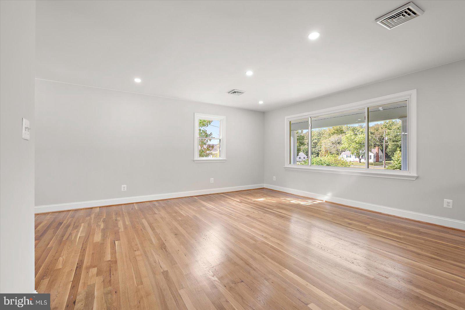 31655 Morris Leonard Road Parsonsburg, MD 21849 - Photo 17 of 90 an empty room with wooden floor and windows