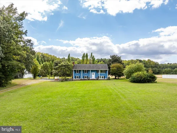 a view of a house with pool and sitting area