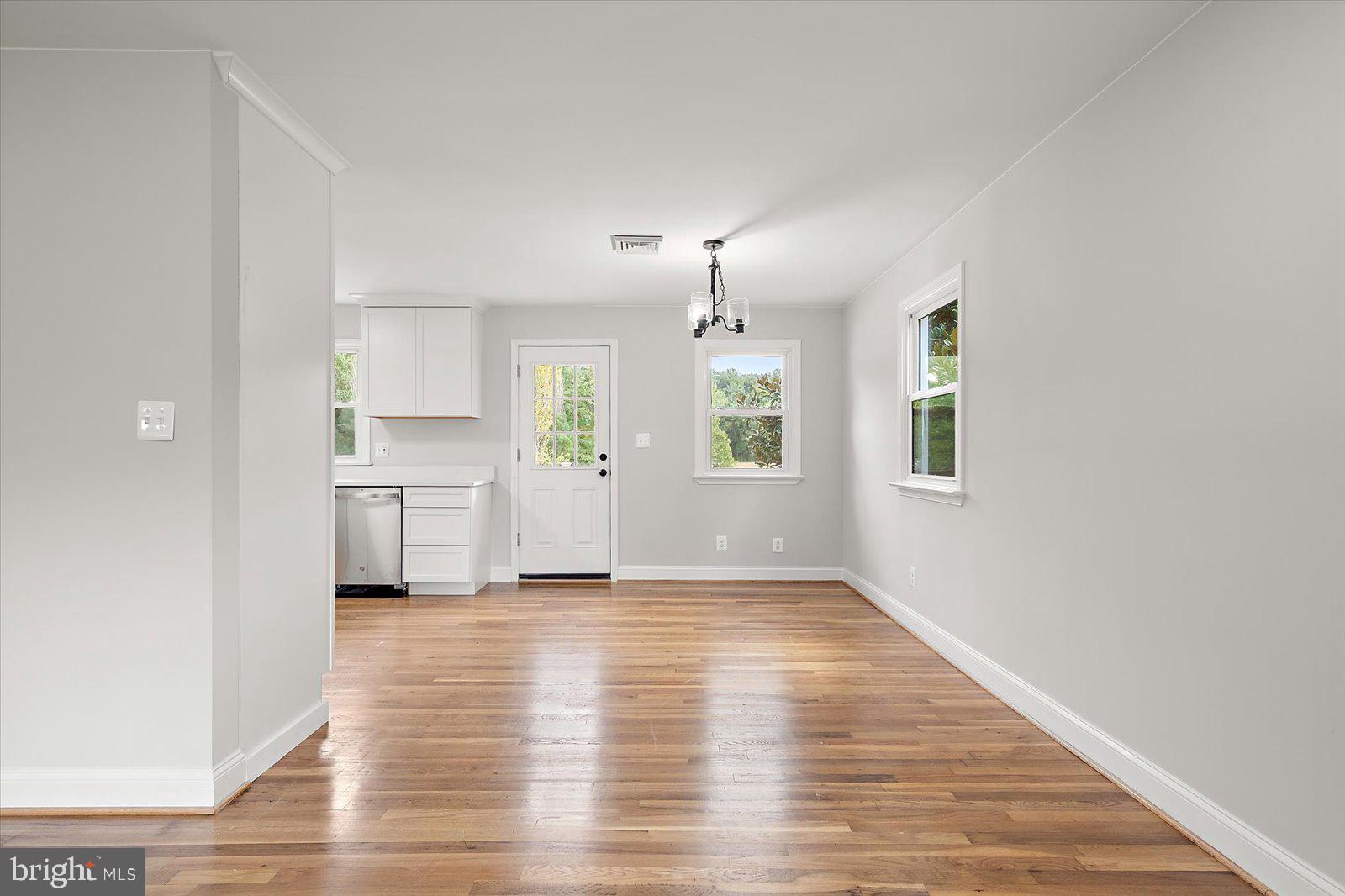 31655 Morris Leonard Road Parsonsburg, MD 21849 - Photo 22 of 90 a view of a kitchen with a sink dishwasher cabinets and wooden floor
