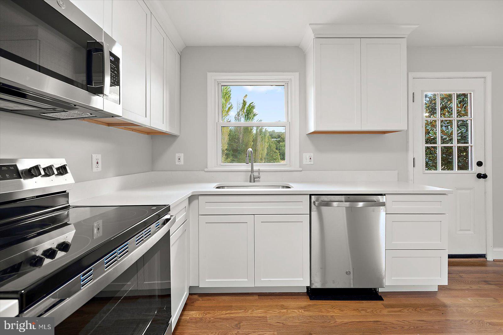 31655 Morris Leonard Road Parsonsburg, MD 21849 - Photo 27 of 90 a kitchen with stainless steel appliances white cabinets and a sink