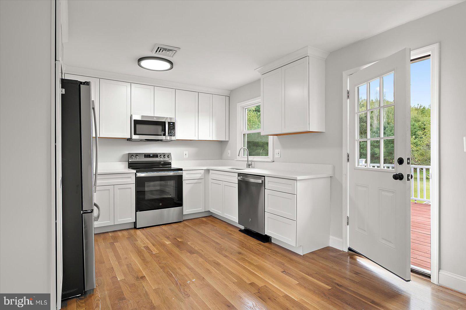 31655 Morris Leonard Road Parsonsburg, MD 21849 - Photo 28 of 90 a kitchen with a stove a sink and a microwave