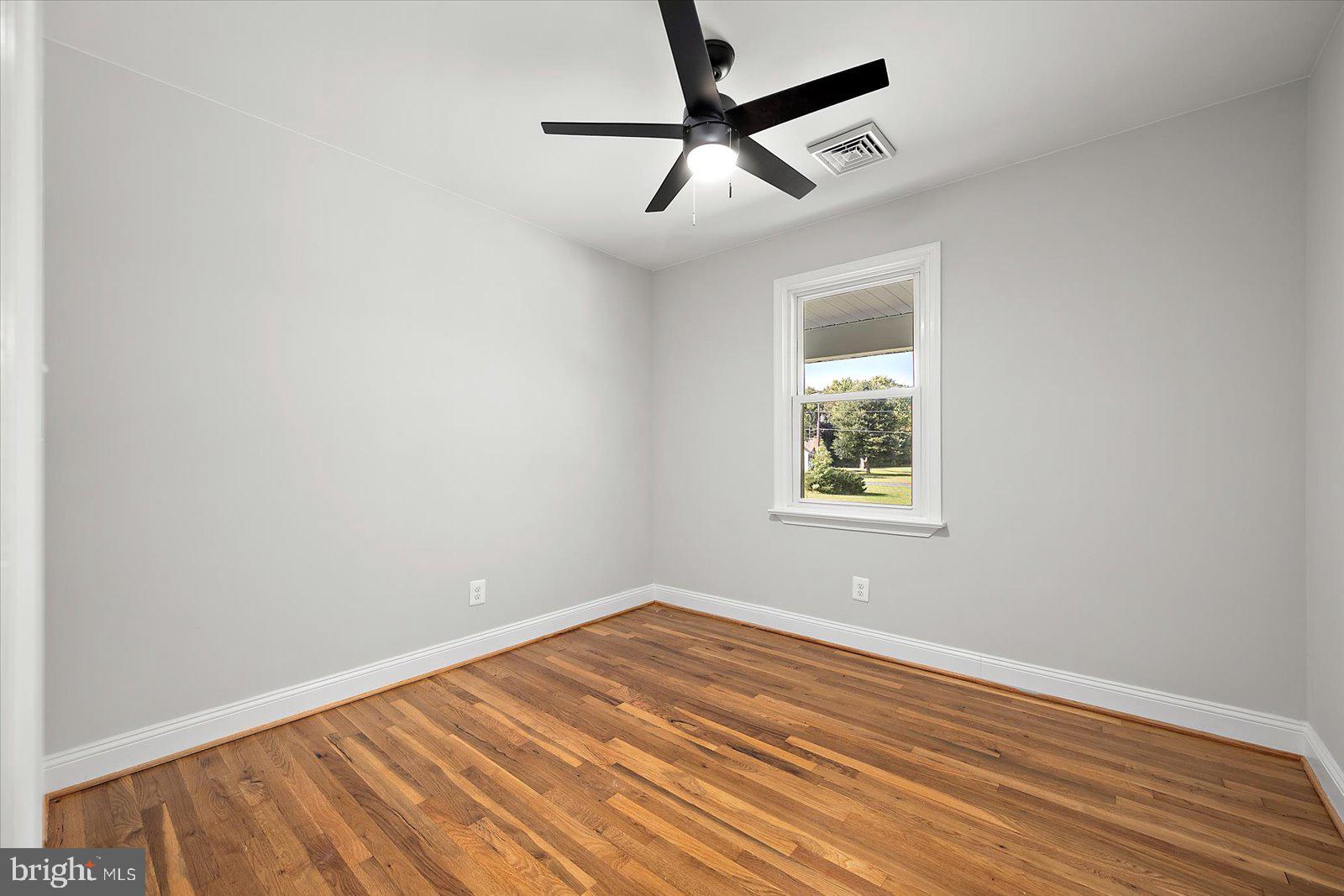 31655 Morris Leonard Road Parsonsburg, MD 21849 - Photo 40 of 90 wooden floor in an empty room with a window