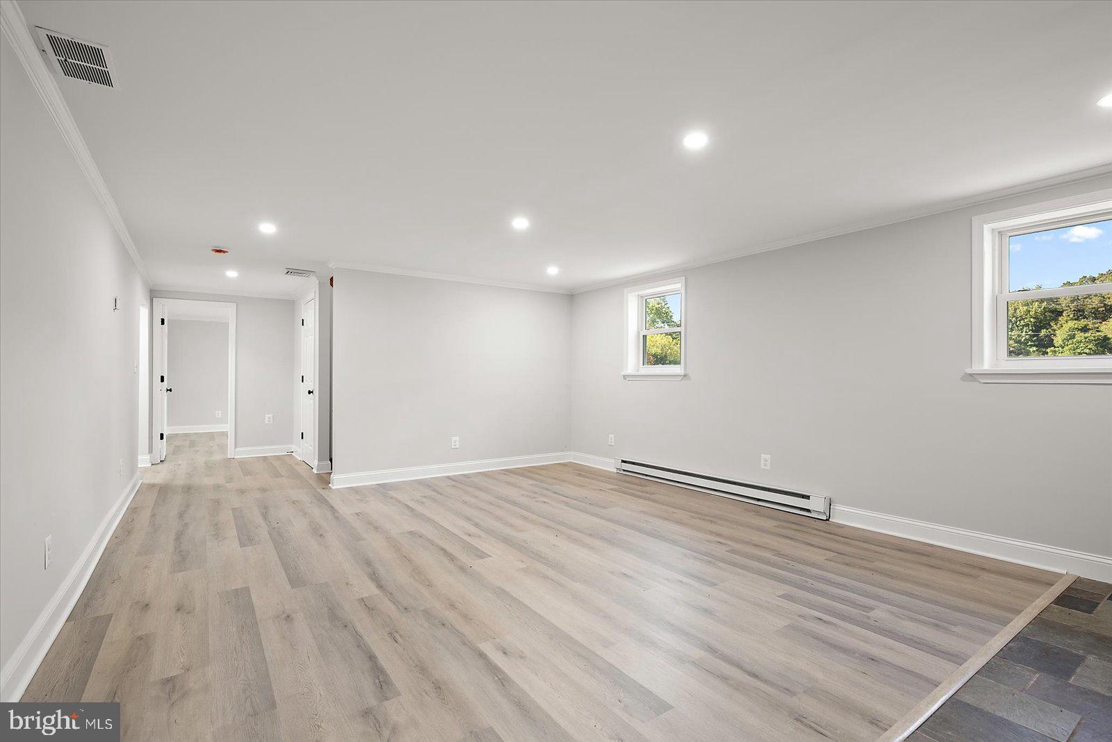 31655 Morris Leonard Road Parsonsburg, MD 21849 - Photo 47 of 90 a view of an empty room with wooden floor and a window
