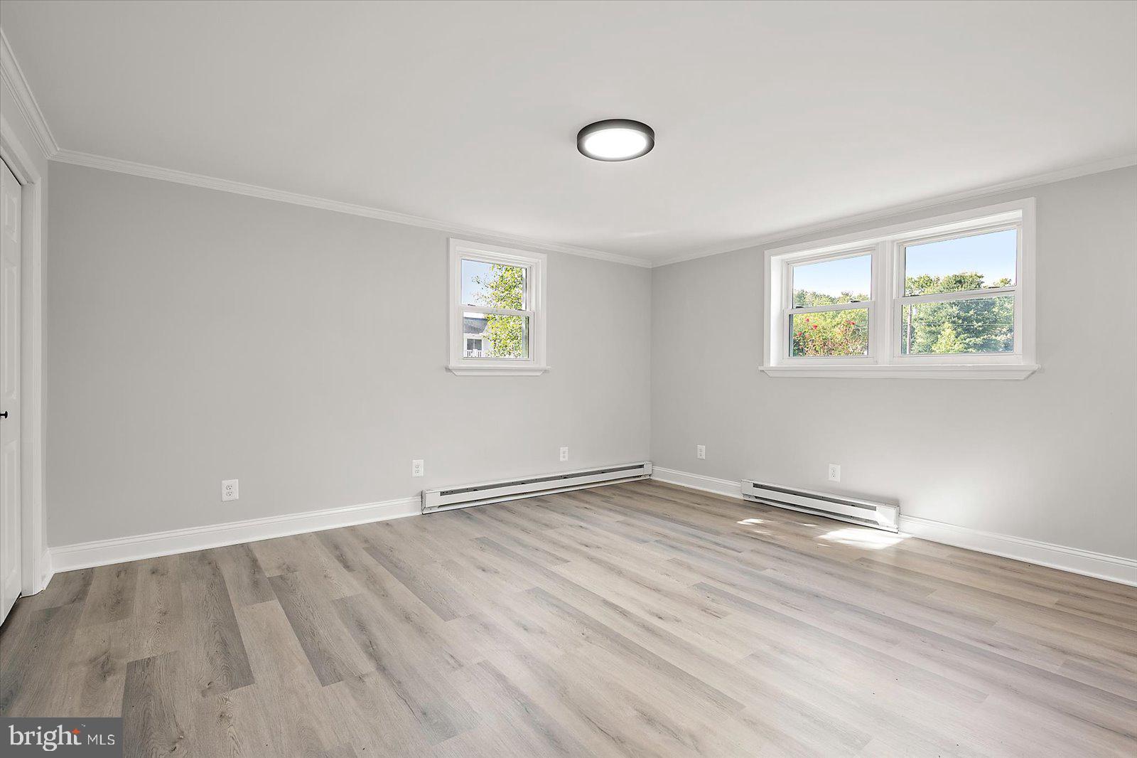 31655 Morris Leonard Road Parsonsburg, MD 21849 - Photo 52 of 90 an empty room with wooden floor and window