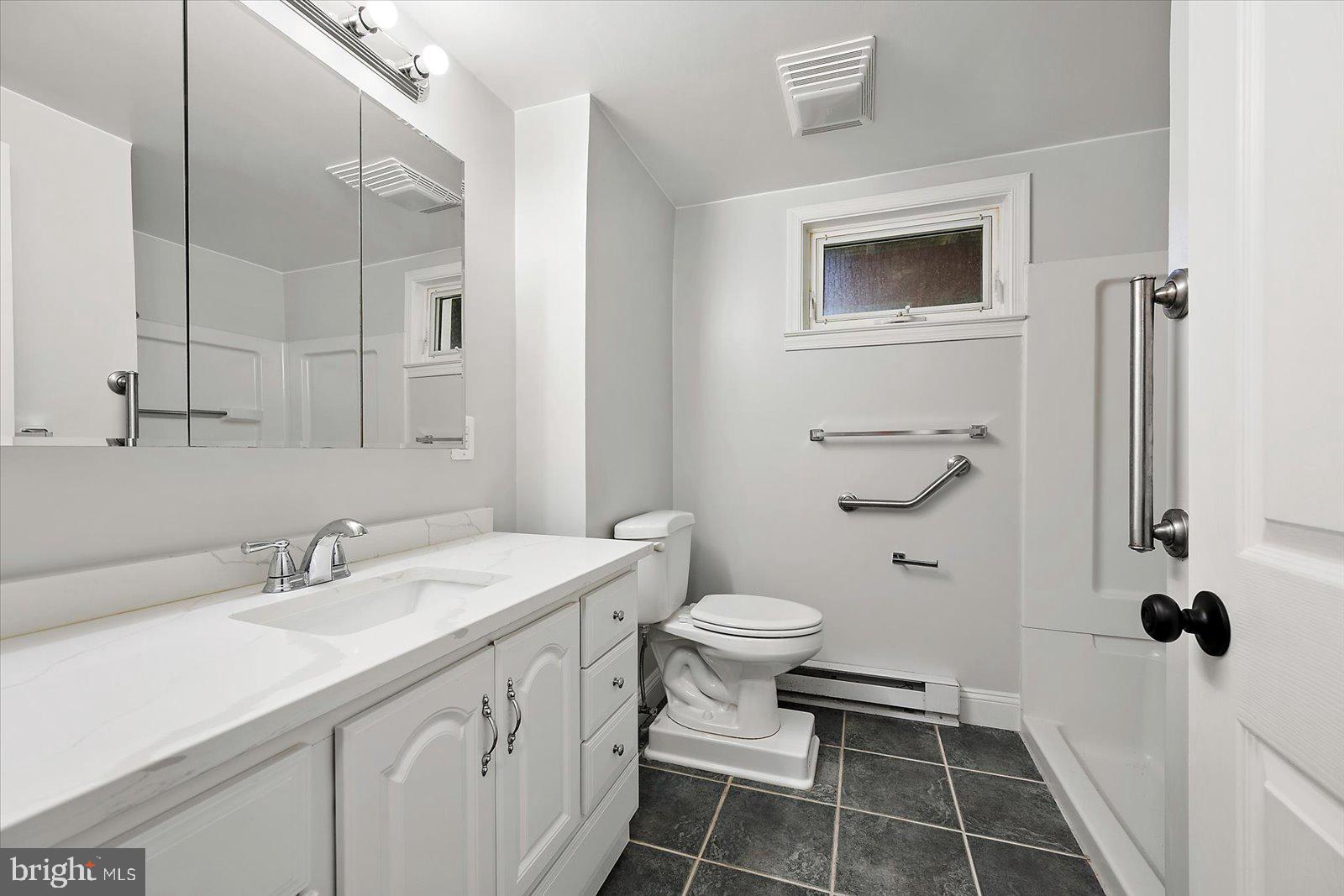 31655 Morris Leonard Road Parsonsburg, MD 21849 - Photo 55 of 90 a bathroom with a sink toilet a mirror and shower