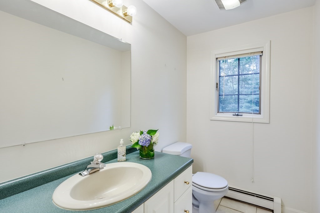 103 Dory Circle Barnstable, MA 02648 - Photo 15 of 42 a bathroom with a sink toilet and a mirror
