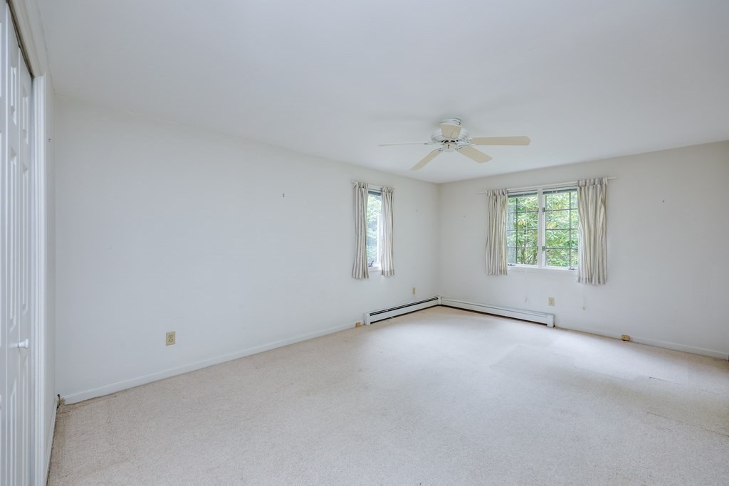 103 Dory Circle Barnstable, MA 02648 - Photo 22 of 42 an empty room with a window and a ceiling fan