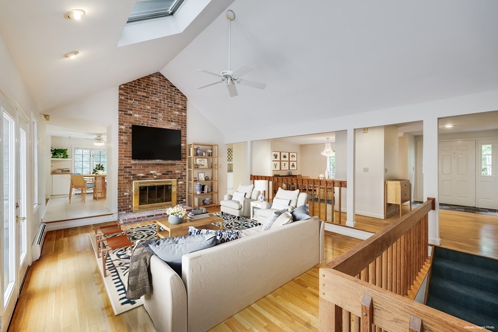 103 Dory Circle Barnstable, MA 02648 - Photo 6 of 42 a living room with furniture a fireplace and a flat screen tv