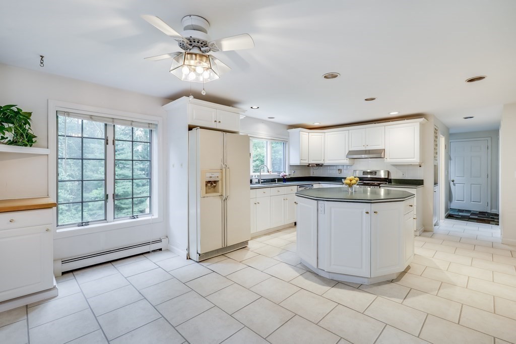 103 Dory Circle Barnstable, MA 02648 - Photo 9 of 42 a kitchen with stainless steel appliances granite countertop a refrigerator a sink a stove a microwave and island