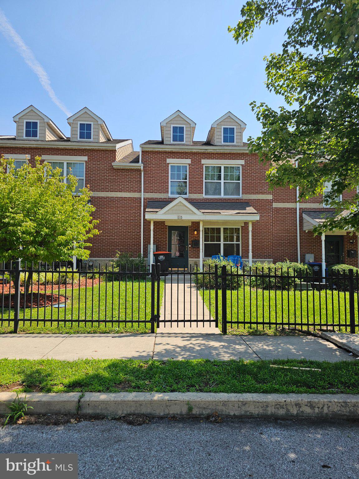 Charming brick home with lush greenery.