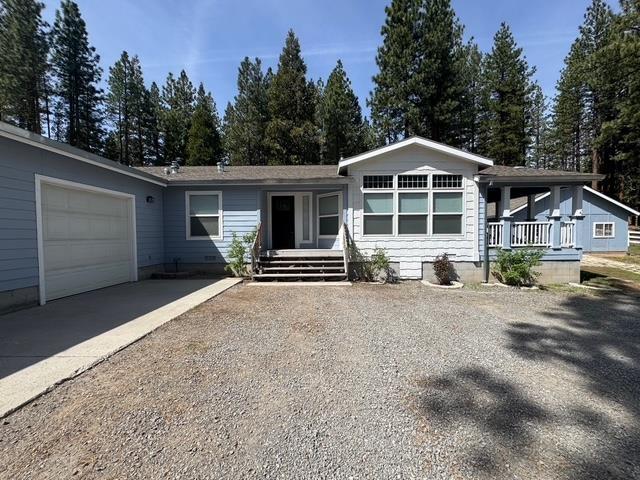 4678 Portola McLears Road Clio, CA 96106 - Photo 1 of 33 a front view of a house with a yard and garage
