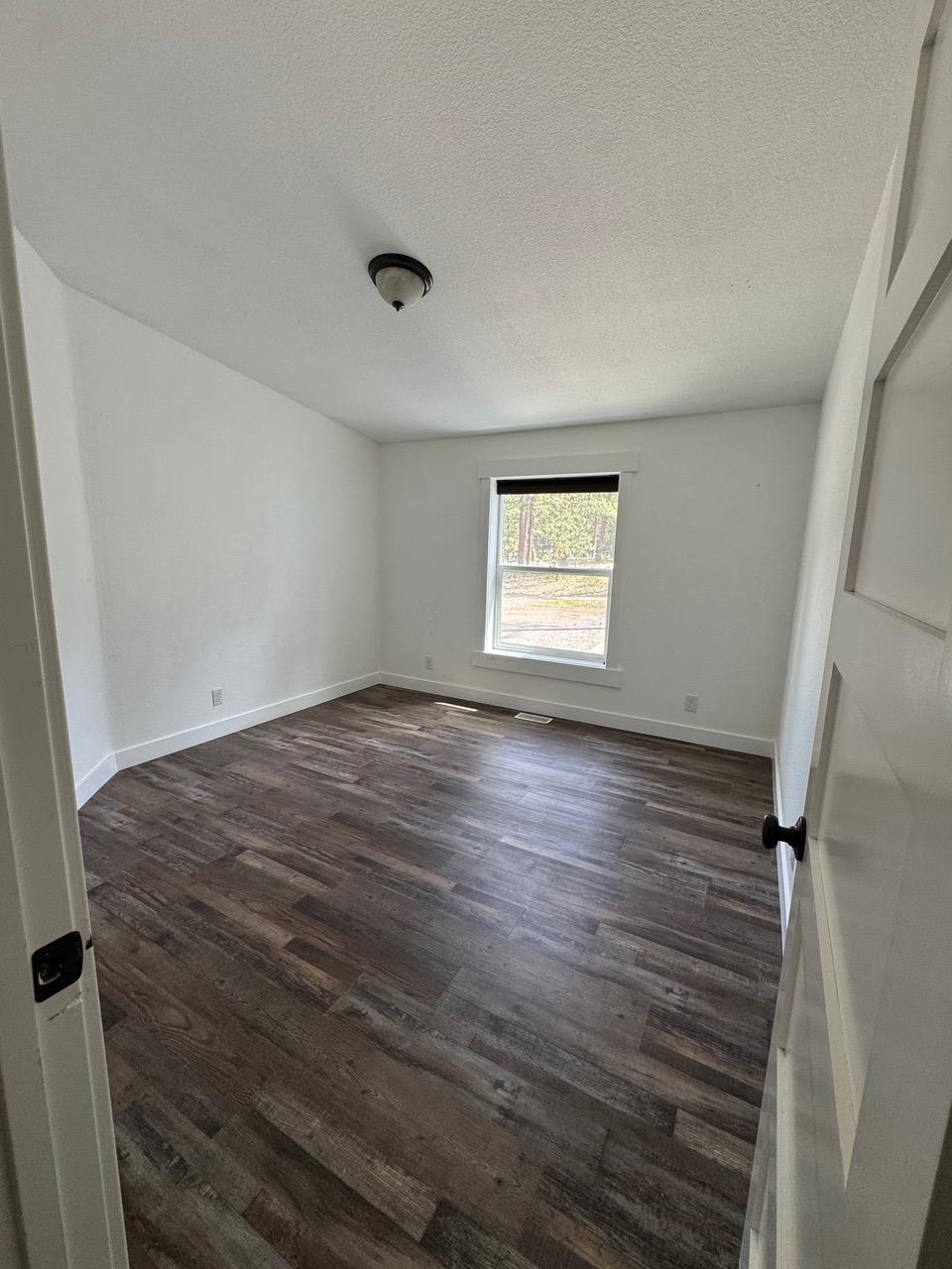 4678 Portola McLears Road Clio, CA 96106 - Photo 25 of 33 a view of empty room with window and wooden floor