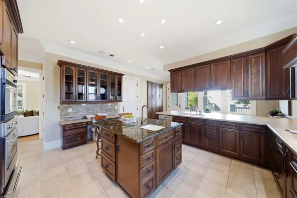 a kitchen with stainless steel appliances granite countertop wooden cabinets and sink