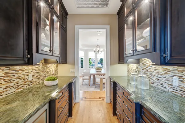 a bathroom with granite countertop a sink and a wooden floor