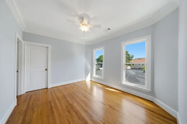 a view of room with window and wooden floor