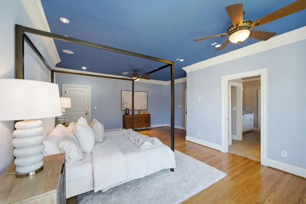 a bedroom with a bed and a chandelier