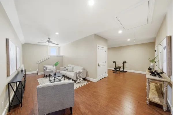 a living room with furniture a large window and kitchen view