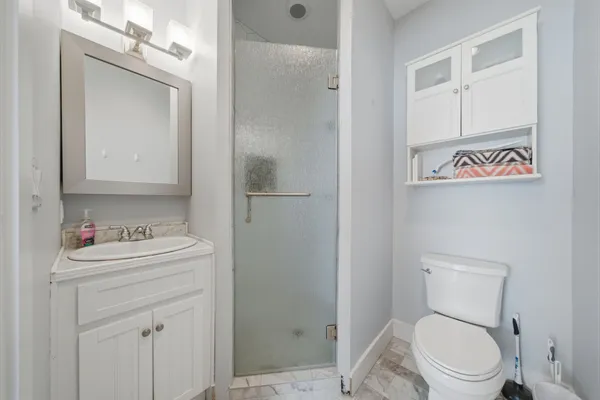 a living room with stainless steel appliances kitchen island granite countertop furniture and a refrigerator
