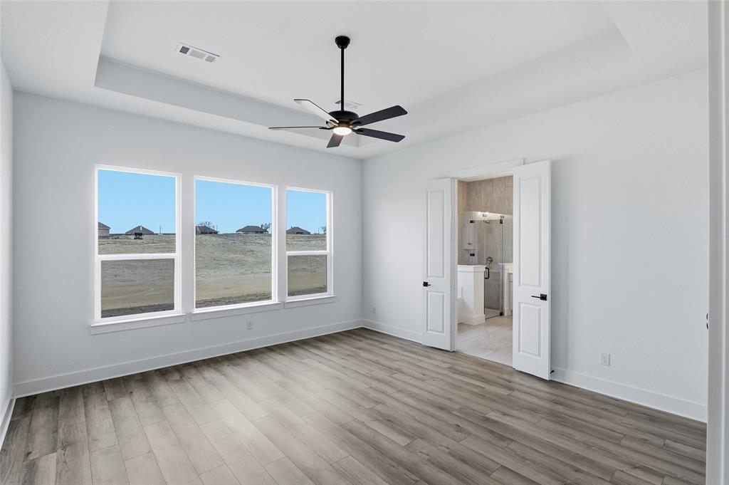 810 Vly Rdg Road Van Alstyne, TX 75495 - Photo 20 of 39 a view of an empty room with a window and wooden floor