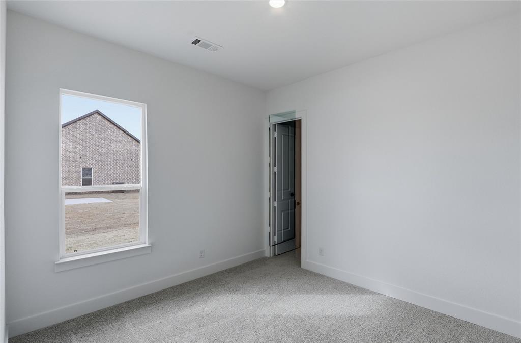 810 Vly Rdg Road Van Alstyne, TX 75495 - Photo 30 of 39 a view of an empty room with closet and a window