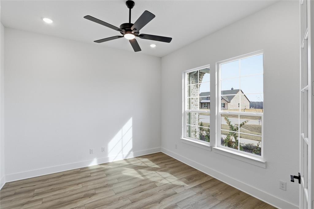 810 Vly Rdg Road Van Alstyne, TX 75495 - Photo 31 of 39 a view of an empty room with wooden floor and a window