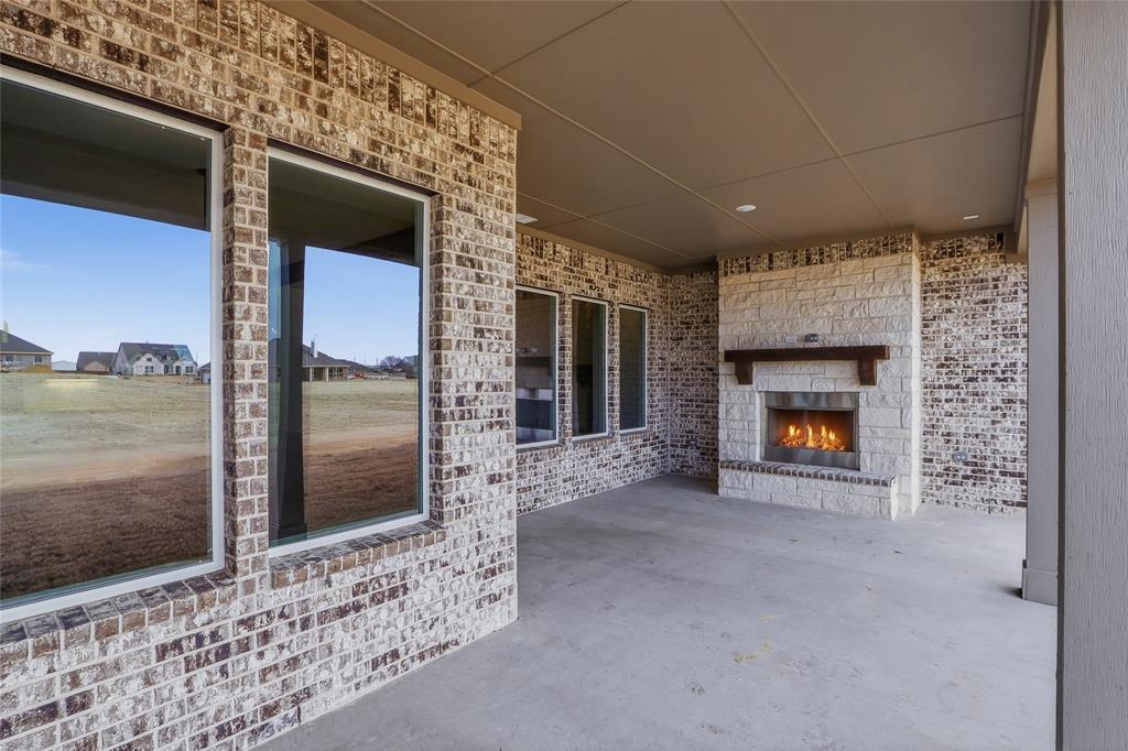 810 Vly Rdg Road Van Alstyne, TX 75495 - Photo 32 of 39 a view of an empty room with a fireplace and a floor to ceiling window
